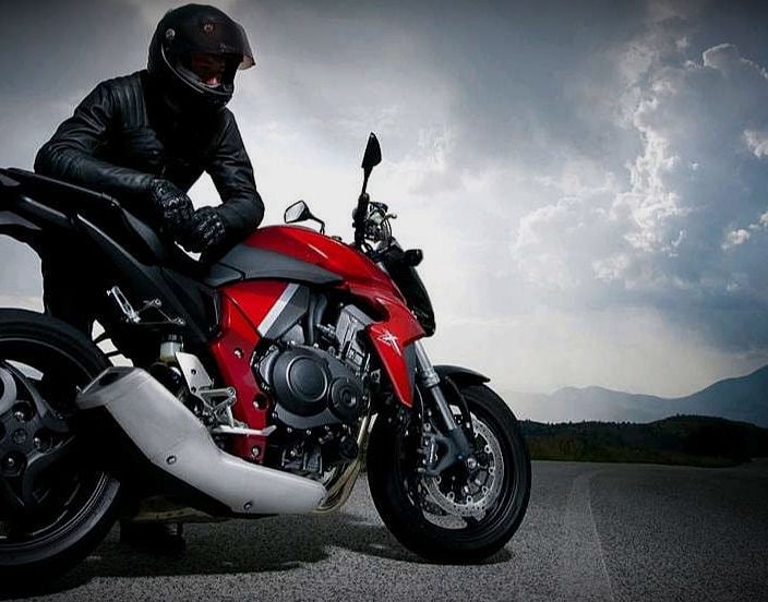 Motorcycle rider and moody clouds