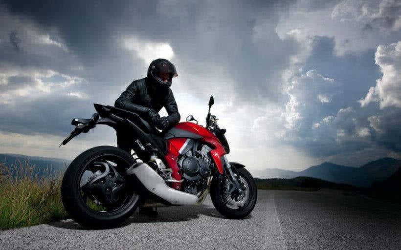 Motorcycle and rider with moody clouds