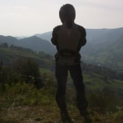 Motorcycle rider looking at mountain scenery